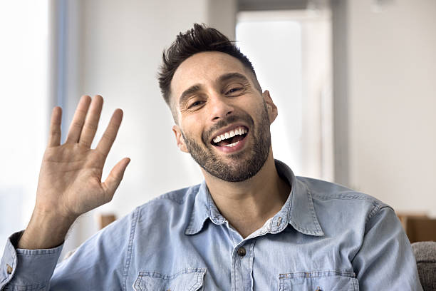 istock Webcam shot man greeting friend engaged in virtual meeting 2203964766