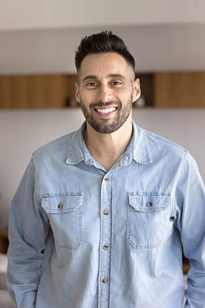 istock Vertical home portrait of young cheerful Hispanic man 2203965255