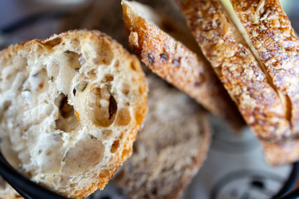 A close-up Turkish macro shot of healthy whole grain bread, showcasing its rich texture and natural cereal composition. Made from wholesome brown grains, not refined white flour, this bread highlights the beauty of organic, nutrient-rich ingredients. Perfect for themes of healthy eating, nutrition, and artisanal baking.