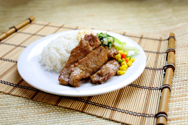 Scallion Pork Chop with Rice, Egg Omelette and sou sauce served in plate isolated on table closeup side view of Hong Kong food