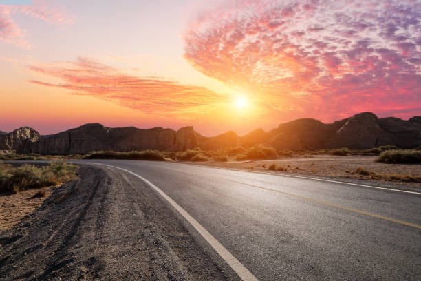 istock A desert road and mountain with beautiful sky clouds at sunset 2203968531