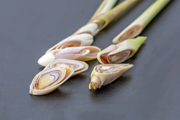 Fresh Lemongrass is cut into pieces and placed on a black plate ready for cooking.