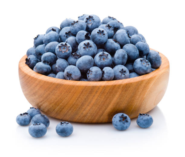istock Fresh blueberries on wooden bowl isolated on white background 2203974453