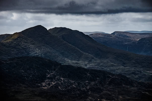 istock Dramatic mountain landscape under cloudy skies in a remote region showcasing rugged terrain. 2203976883
