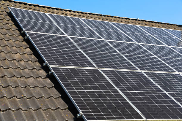 istock Solar panels converting sunlight into renewable energy on rooftop 2203977419