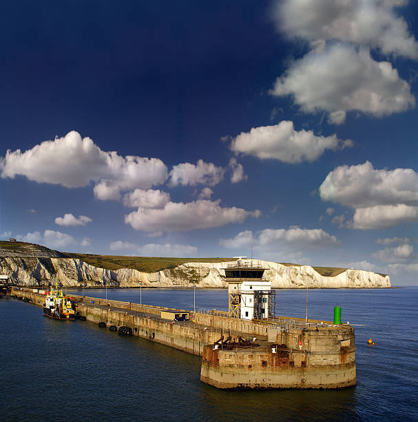 Trail along the White Cliffs of Dover with the sea in the background. Green meadows and classic English countryside paths. Concept of rural tourism, hiking, and exploring the scenic coast of England. High quality photo