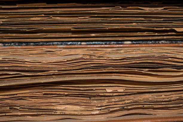 istock Close-Up View of Vintage Newspaper Stack Showing Aged Pages 2203977677