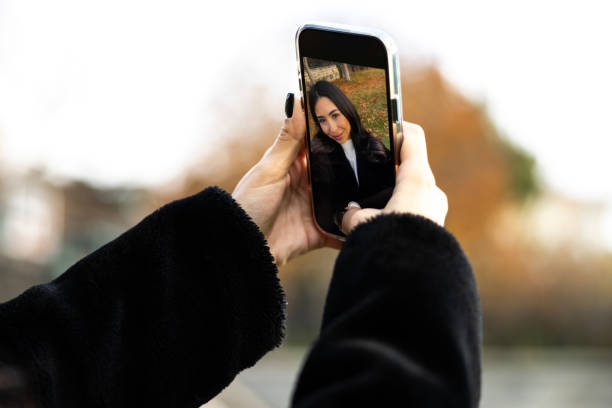 istock Elegant woman is taking a selfie withe her mobile phone. 2203977981