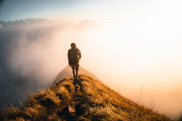 istock Hiker explores trail on mountain ridge at sunrise 2203978416