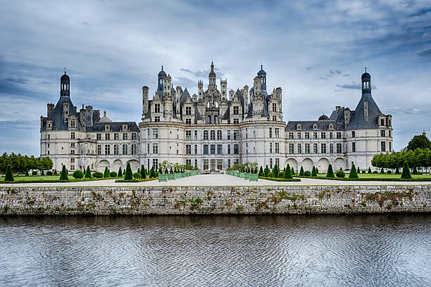 Chambord, France - June 13, 2024: As seen across the moat, the Chateau de Chambord in the Loire Valley is a magnificent French hunting lodge for the royal family.