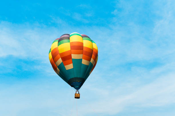 istock Colorful hot air balloon floating in blue sky 2203983666