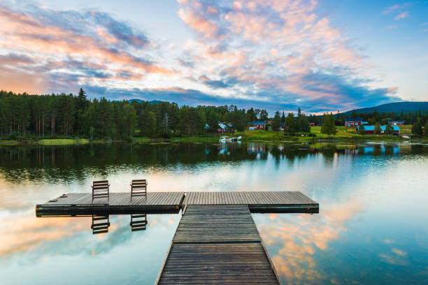 istock Tranquil evening at a Swedish lake with dock and reflections under a colorful sky 2203984177