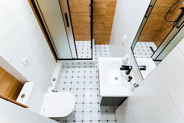 Discover a modern bathroom interior design featuring a shower, sink, and toilet, all presented in soothing neutral tones for a stylish ambiance