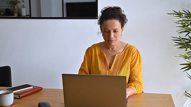 istock Woman Working Remotely on Laptop in Comfortable Modern Home Office 2203987170
