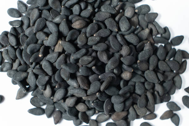 istock Black sesame seeds scattered on a white background macro top view 2203987351