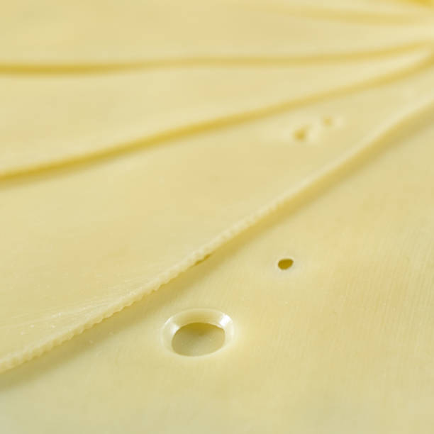 istock Semi-hard cheese close-up, thin slices 2203987415