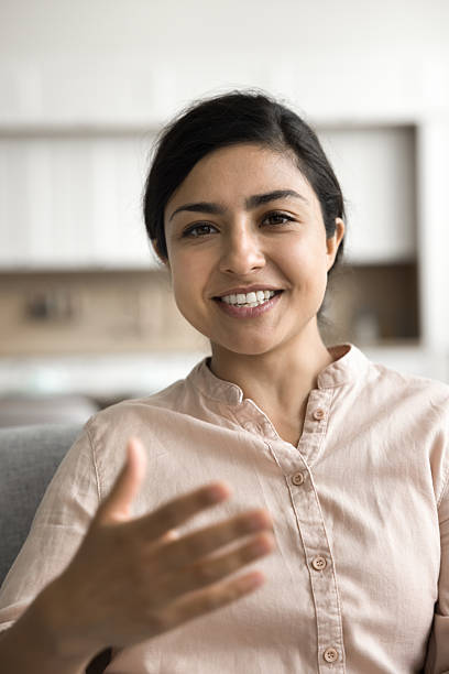 istock Smiling girl look at camera talk by videocall from home 2203992965