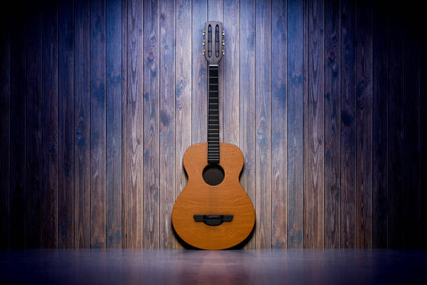 istock Musical instrument in a rustic interior. Guitar lessons. Empty space for your design, poster, announcement. Classic acoustic guitar stands near a wooden wall in a bar. 3d render. 2203992970