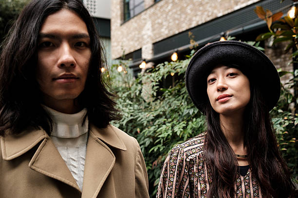 istock Fashionable asian couple posing in urban setting 2203994239