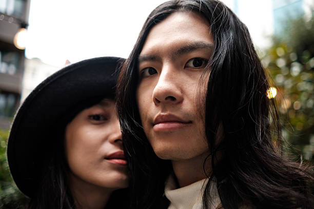 istock Young couple posing together outdoors in urban setting 2203994244