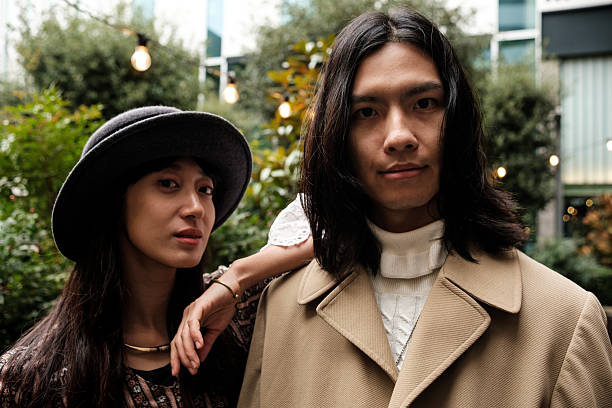 istock Fashionable couple posing in urban setting, embracing modern style 2203994248