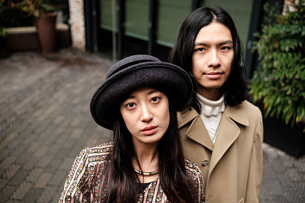 istock Young asian couple posing together outdoors in urban setting 2203994265