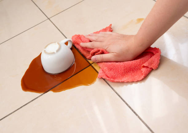 istock Spilled coffee, coffe puddle stain on tiled floor, messy leak with fallen cup, brown drink spillage 2203995225