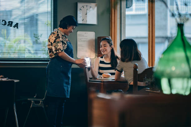 istock Asian Female Customer Scanning Smartphone Payment Code for Checkout: Cashless Payment and Technological Convenience in Modern Shopping Experience 2203995576