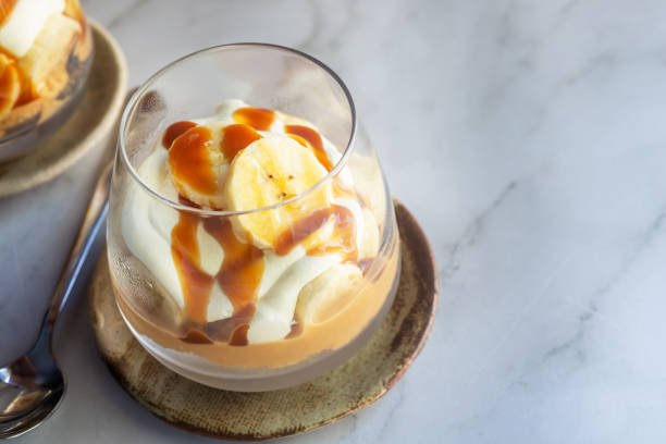 istock homemade no-bake banoffee pie cups on white table. 2203998012