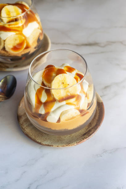 istock homemade no-bake banoffee pie cups on white table. 2203998019