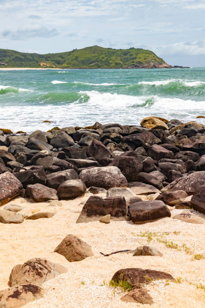 istock Rocks, sand and waves on the beach 2204001171