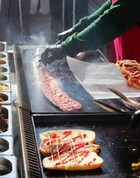 preparation of stuffed sandwiches at a street food stand on a hot griddle
