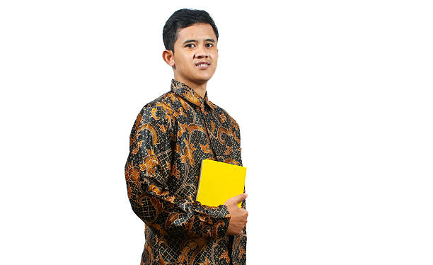 istock young teacher carrying a book with a smiling expression full of happiness 2204009017
