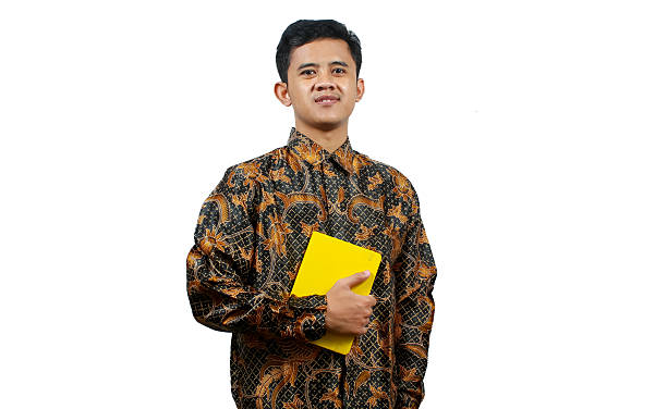 istock young teacher carrying a book with a smiling expression full of happiness 2204009047