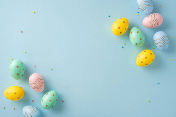 istock Colorful decorative Easter eggs arranged on a soft blue pastel background for a festive theme 2204010891