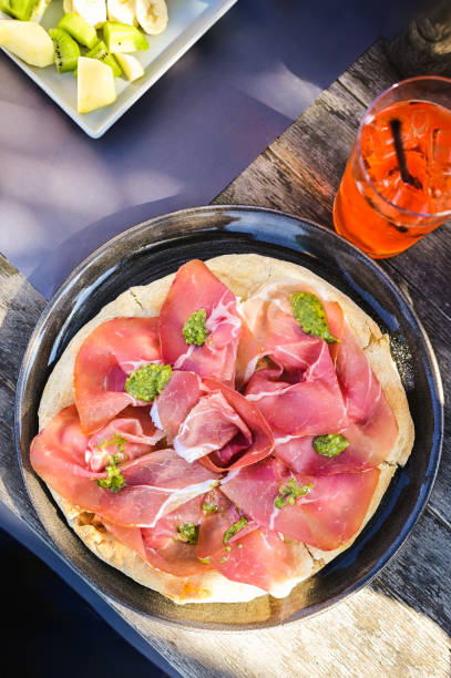 Gourmet pizza with Serrano ham or prosciutto crudo