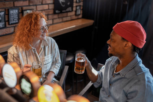 istock Friends Enjoying Drinks at a Cozy Pub 2204012718