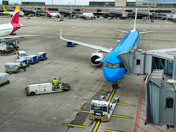 Airport ZUrich ZRH with a KLM aircrafta at the gates and on the airfield. Captured on a cloudy day.