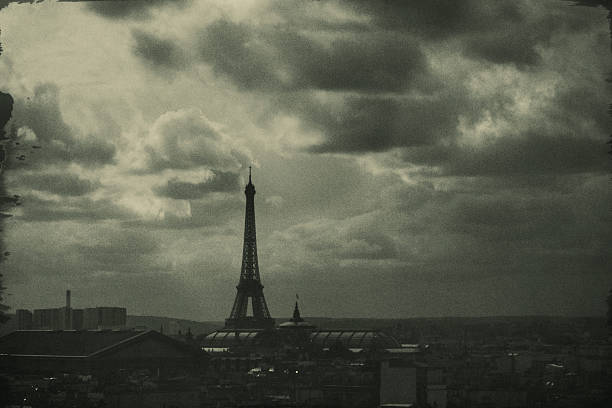 Upward view of the Eiffel Tower at night with a star-filled sky.