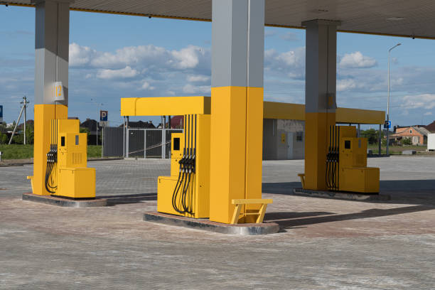 istock Empty gas station features several yellow fuel dispensers under a bright sky, illustrating a typical fueling location 2204016046