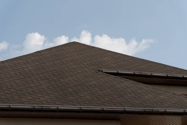 istock Modern tiled roof construction highlights quality workmanship on a residential house set against a bright blue sky with white clouds 2204016047