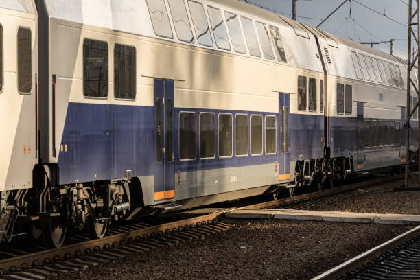 istock A sleek double-decker train is parked at the station, illuminated by warm late afternoon sunlight casting shadows on the tracks 2204016093