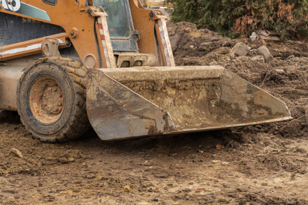 istock A construction vehicle is actively moving and leveling dirt at a site, contributing to the groundwork for future development 2204016146