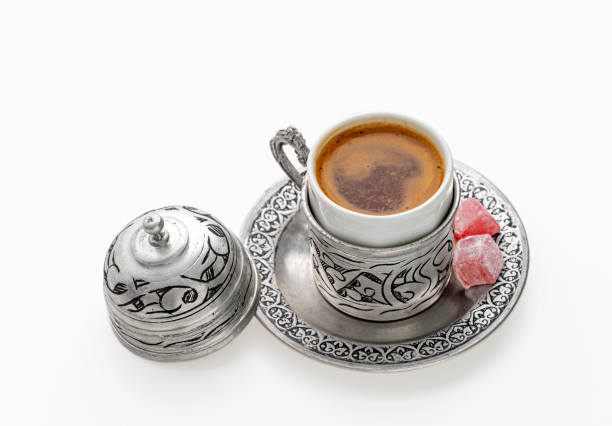 Turkish coffee and Turkish delight with traditional cup over white background