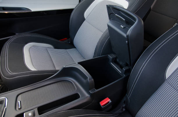 istock Modern car interior detail: center console with armrest and storage 2204025211