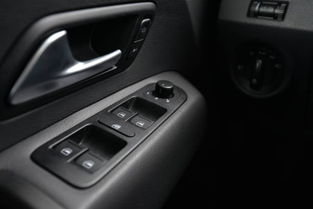 istock Close up of car door panel with window controls and door handle 2204025572