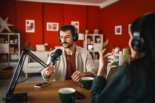 istock man host interviewer woman guest record podcast at home studio 2204026748