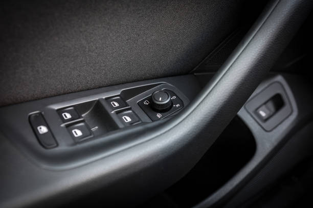 istock Close up of car door panel with power window and mirror controls 2204027016