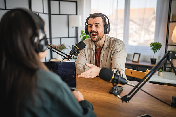 istock man host interviewer woman guest record podcast at home studio 2204027420