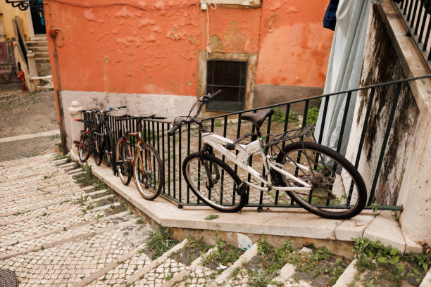 istock Old bicycles locked to railing on stairs 2204030637